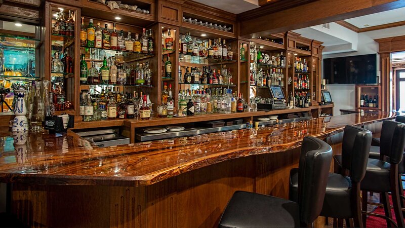 Bar seating room with view of liquor bottles